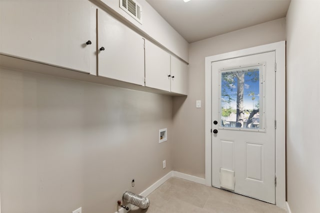 laundry area with light tile patterned flooring, cabinets, and washer hookup