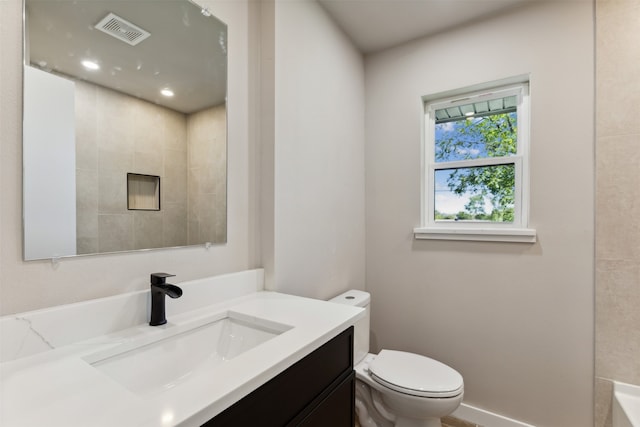 bathroom featuring vanity and toilet