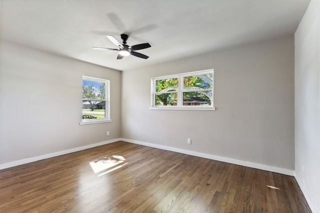 unfurnished room with dark hardwood / wood-style flooring and ceiling fan