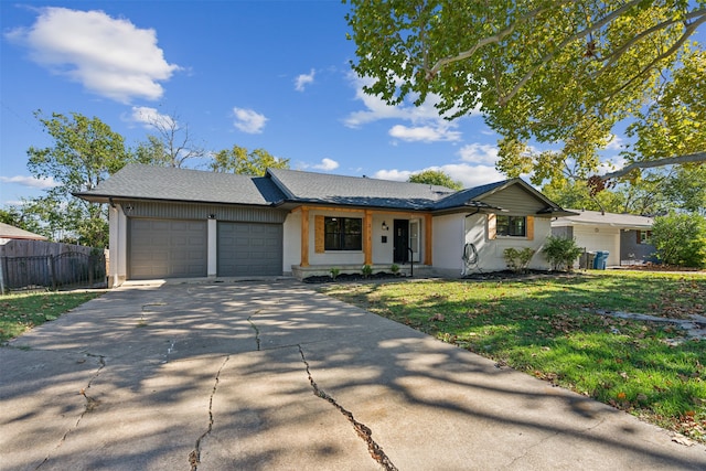 ranch-style house with a garage and a front lawn