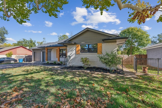 ranch-style house featuring a front lawn and a garage