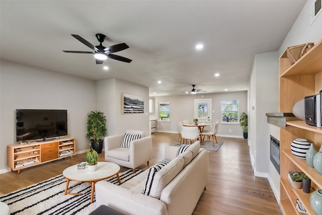 living room featuring hardwood / wood-style flooring and ceiling fan