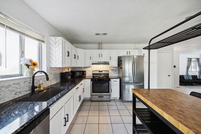 kitchen featuring light tile patterned flooring and a textured ceiling