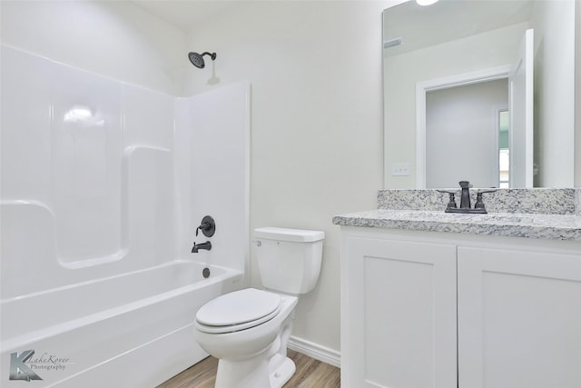 full bathroom featuring shower / bathing tub combination, wood-type flooring, vanity, and toilet