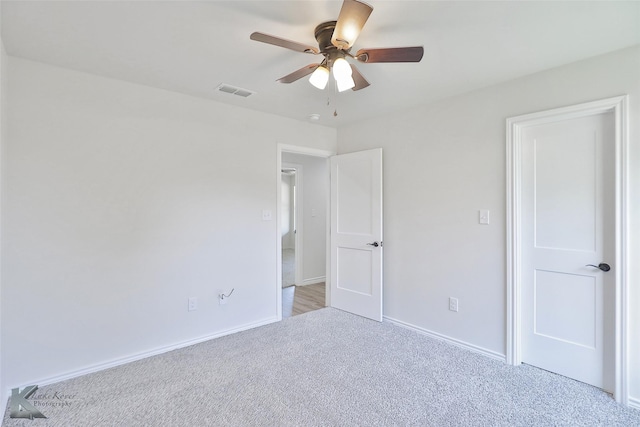 unfurnished bedroom featuring light carpet and ceiling fan