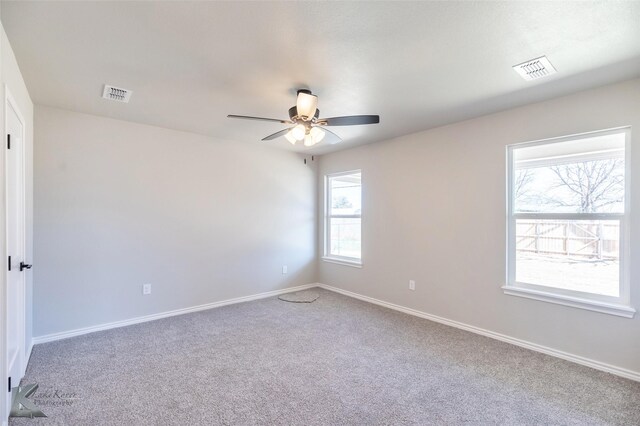 carpeted empty room featuring ceiling fan