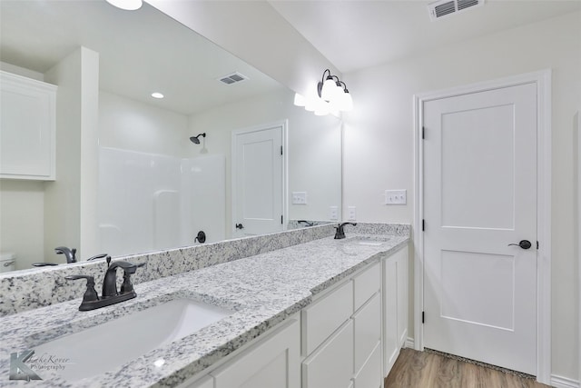 bathroom featuring hardwood / wood-style floors, vanity, and toilet