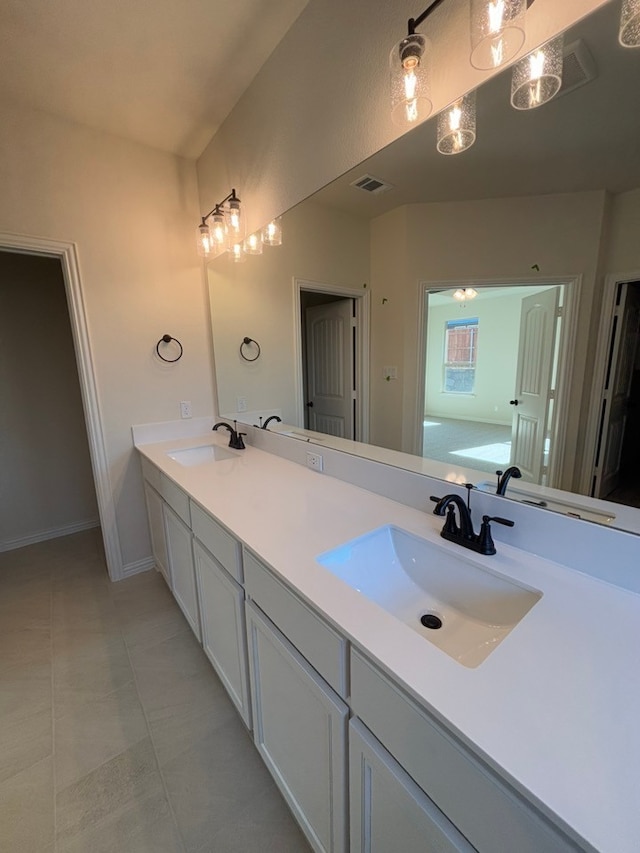 bathroom with tile patterned flooring, vanity, and a bathing tub