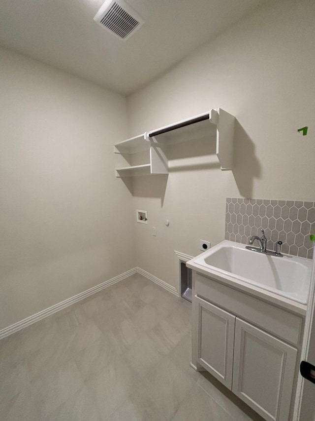 laundry room featuring electric dryer hookup, cabinets, sink, and hookup for a washing machine