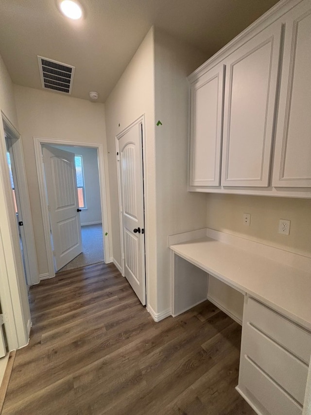 corridor with dark hardwood / wood-style floors