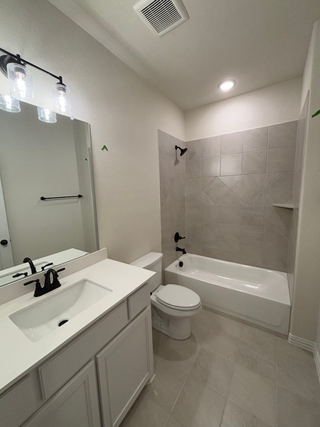 full bathroom featuring tile patterned flooring, toilet, vanity, and tiled shower / bath