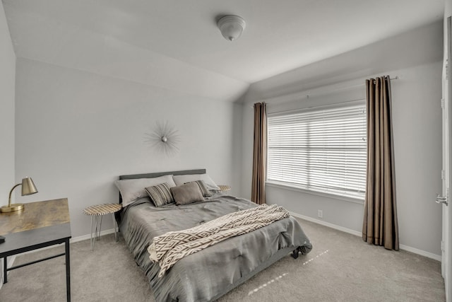 bedroom with light colored carpet and vaulted ceiling