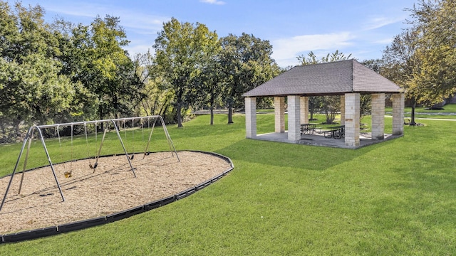 view of property's community featuring a playground, a lawn, and a gazebo