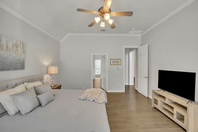 bedroom featuring hardwood / wood-style flooring, ceiling fan, and crown molding