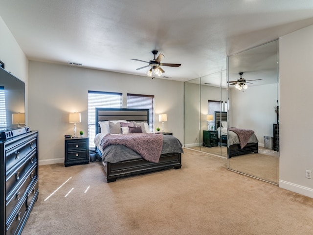 bedroom featuring ceiling fan and carpet