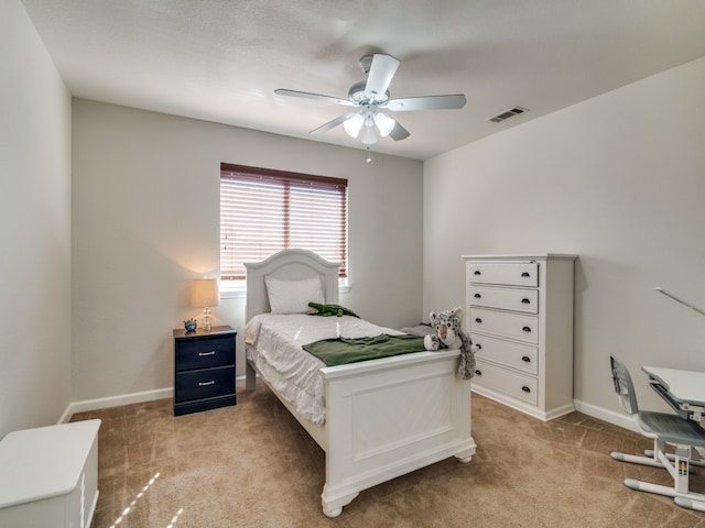 bedroom featuring ceiling fan and light carpet