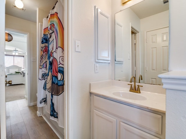 bathroom featuring vanity, hardwood / wood-style flooring, and ceiling fan