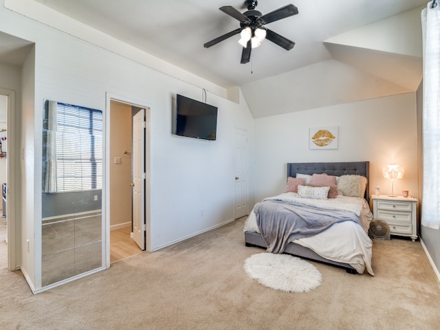 carpeted bedroom featuring ceiling fan and vaulted ceiling