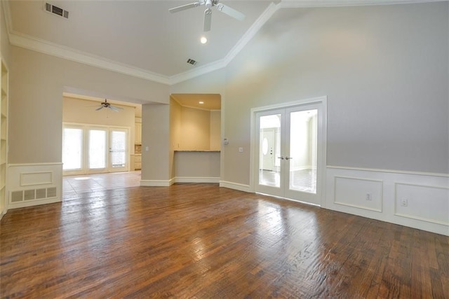 unfurnished living room featuring ceiling fan, french doors, a high ceiling, wood-type flooring, and ornamental molding