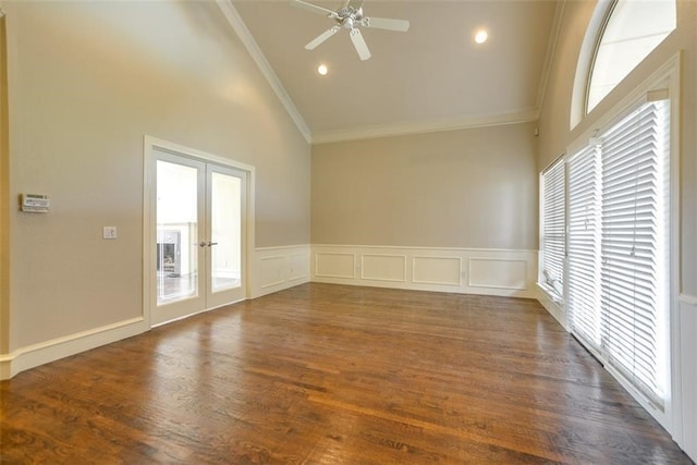 unfurnished room with dark hardwood / wood-style floors, a healthy amount of sunlight, ornamental molding, and french doors