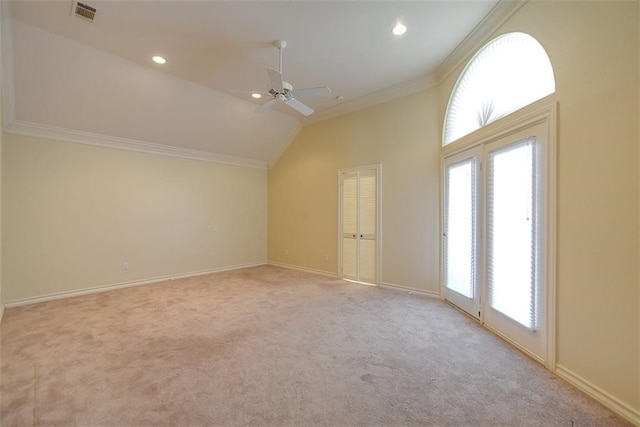 bonus room with ceiling fan, plenty of natural light, light colored carpet, and vaulted ceiling