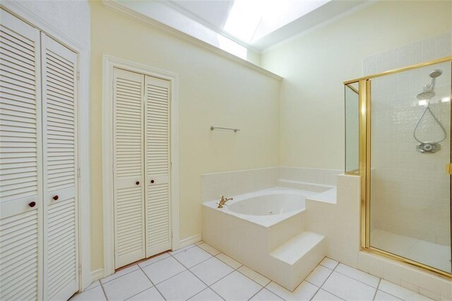 bathroom with plus walk in shower, a skylight, tile patterned floors, and ornamental molding