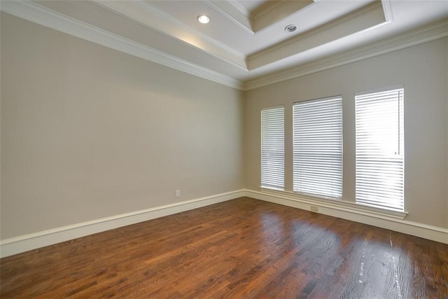 unfurnished room with dark hardwood / wood-style flooring, ornamental molding, and a tray ceiling