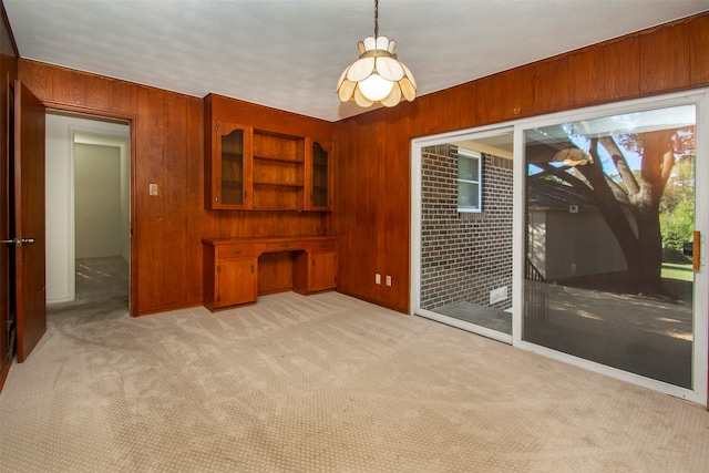 living room with light colored carpet and wood walls