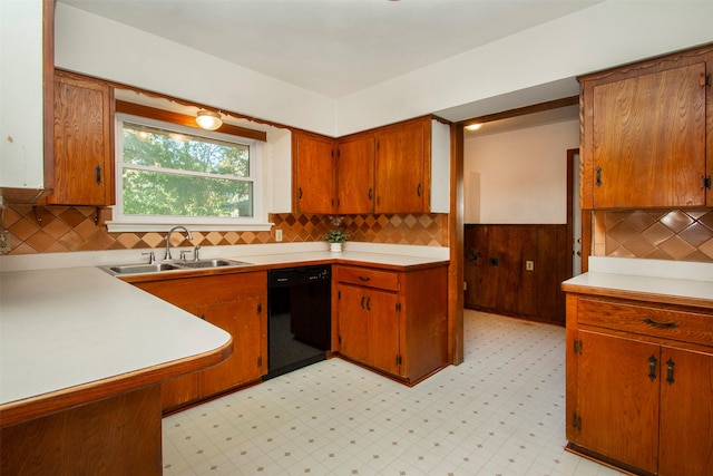 kitchen with decorative backsplash, black dishwasher, and sink