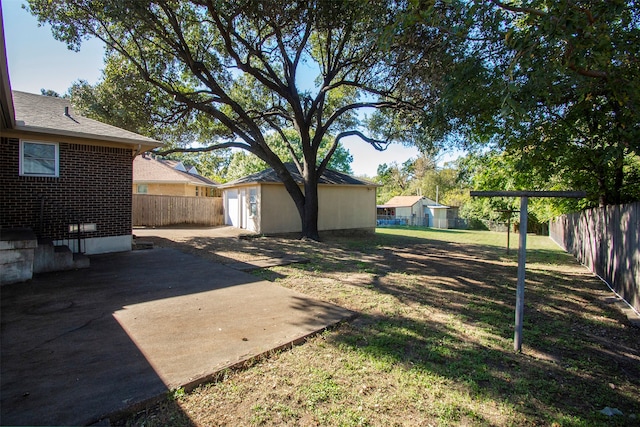 view of yard featuring a patio area and an outdoor structure