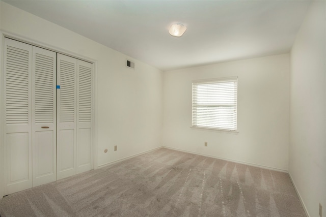 unfurnished bedroom featuring a closet and carpet