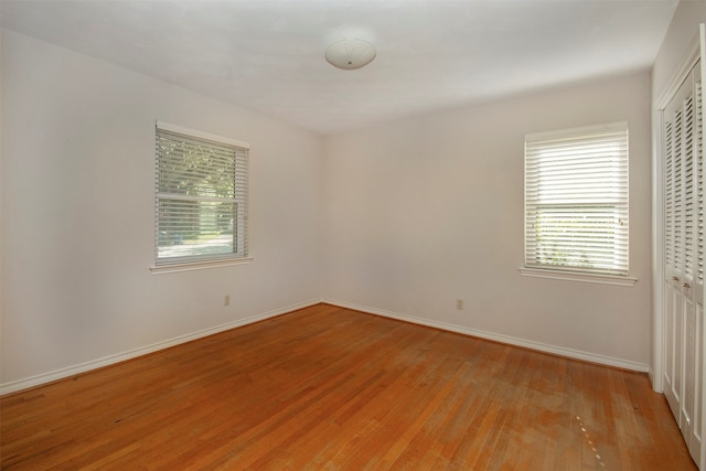 empty room with light hardwood / wood-style flooring