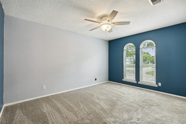 spare room with ceiling fan, carpet floors, and a textured ceiling