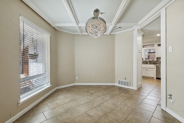 tiled spare room with coffered ceiling, crown molding, and sink