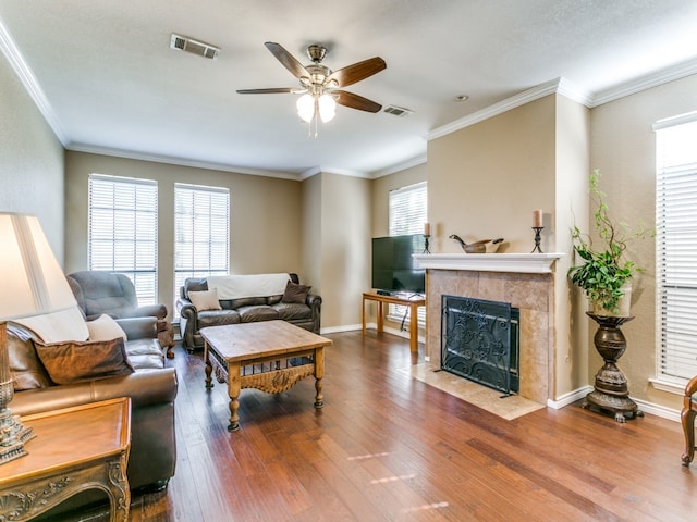 living room featuring ornamental molding, wood-type flooring, and a premium fireplace