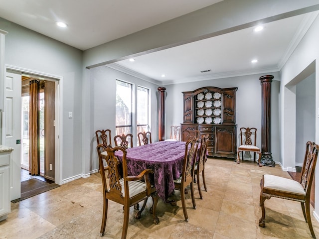 dining room featuring ornamental molding and decorative columns