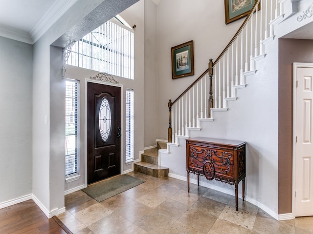 foyer featuring ornamental molding