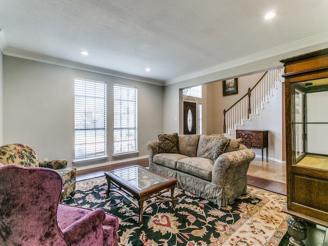 living room with crown molding and light hardwood / wood-style flooring