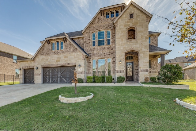 view of front of property with a garage and a front lawn