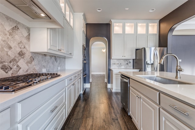 kitchen with sink, appliances with stainless steel finishes, tasteful backsplash, dark hardwood / wood-style flooring, and white cabinetry