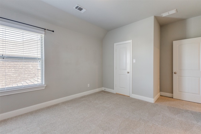 unfurnished bedroom featuring light carpet