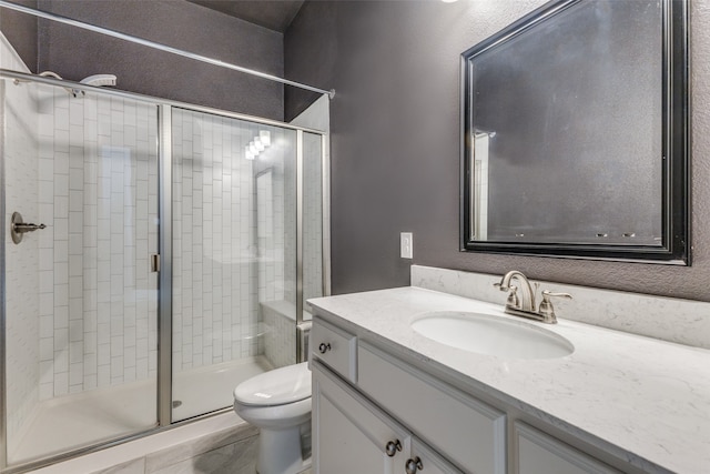 bathroom with vanity, toilet, and an enclosed shower