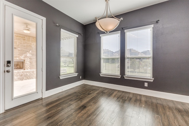 unfurnished dining area featuring dark hardwood / wood-style flooring