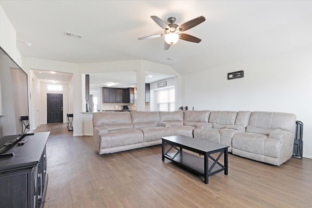 living room featuring ceiling fan and wood-type flooring