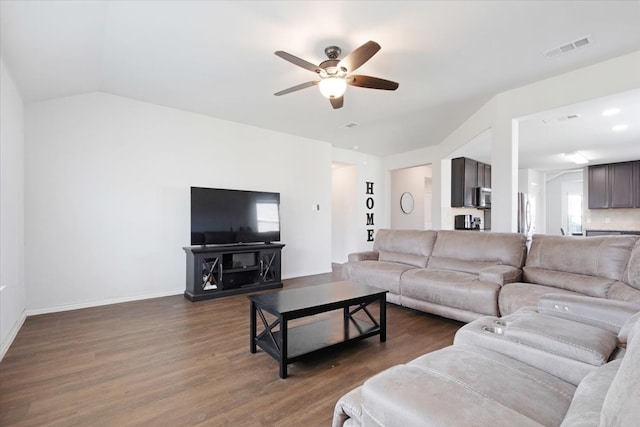 living room featuring ceiling fan, dark hardwood / wood-style flooring, and vaulted ceiling