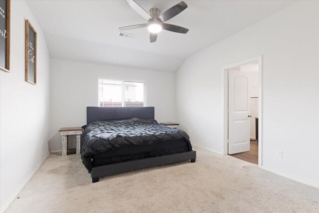 carpeted bedroom with vaulted ceiling and ceiling fan