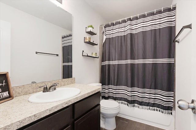 full bathroom featuring hardwood / wood-style floors, vanity, toilet, and shower / tub combo