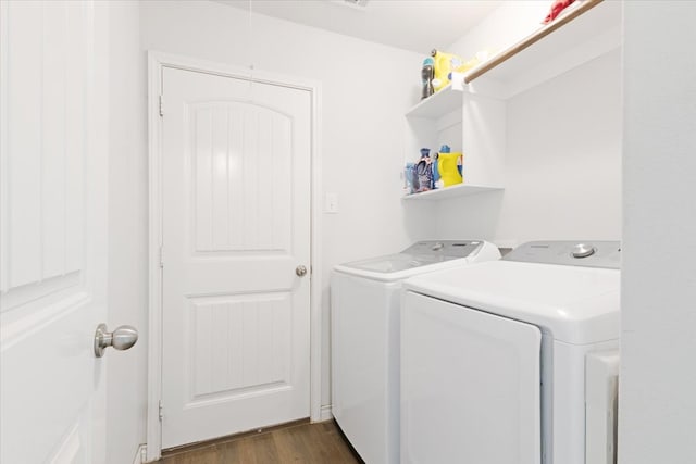 laundry room featuring dark hardwood / wood-style flooring and washer and clothes dryer