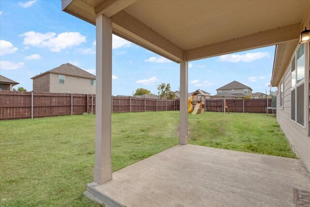 view of yard featuring a patio area and a playground