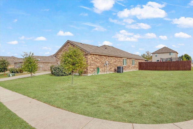 view of home's exterior featuring a lawn and central air condition unit